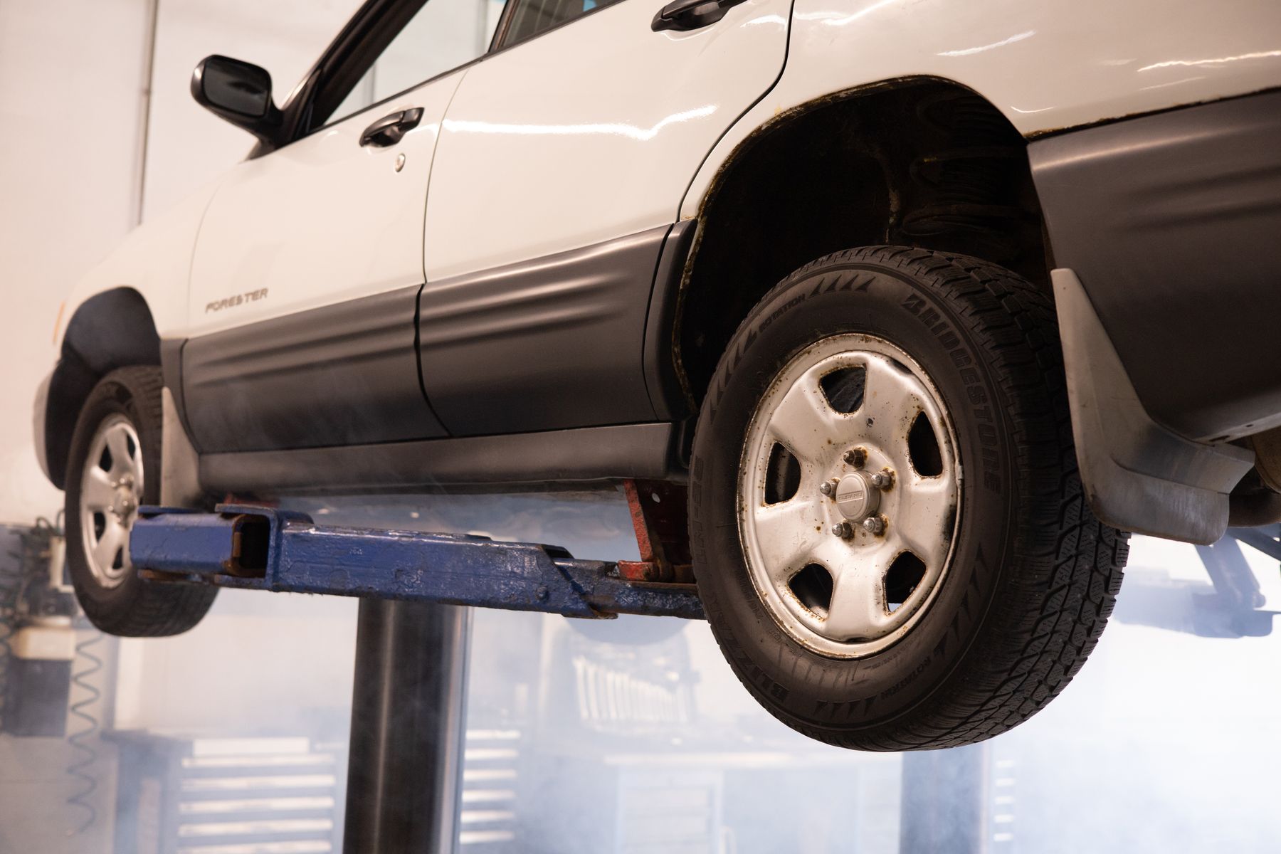 Car raised on a lift in a repair workshop
